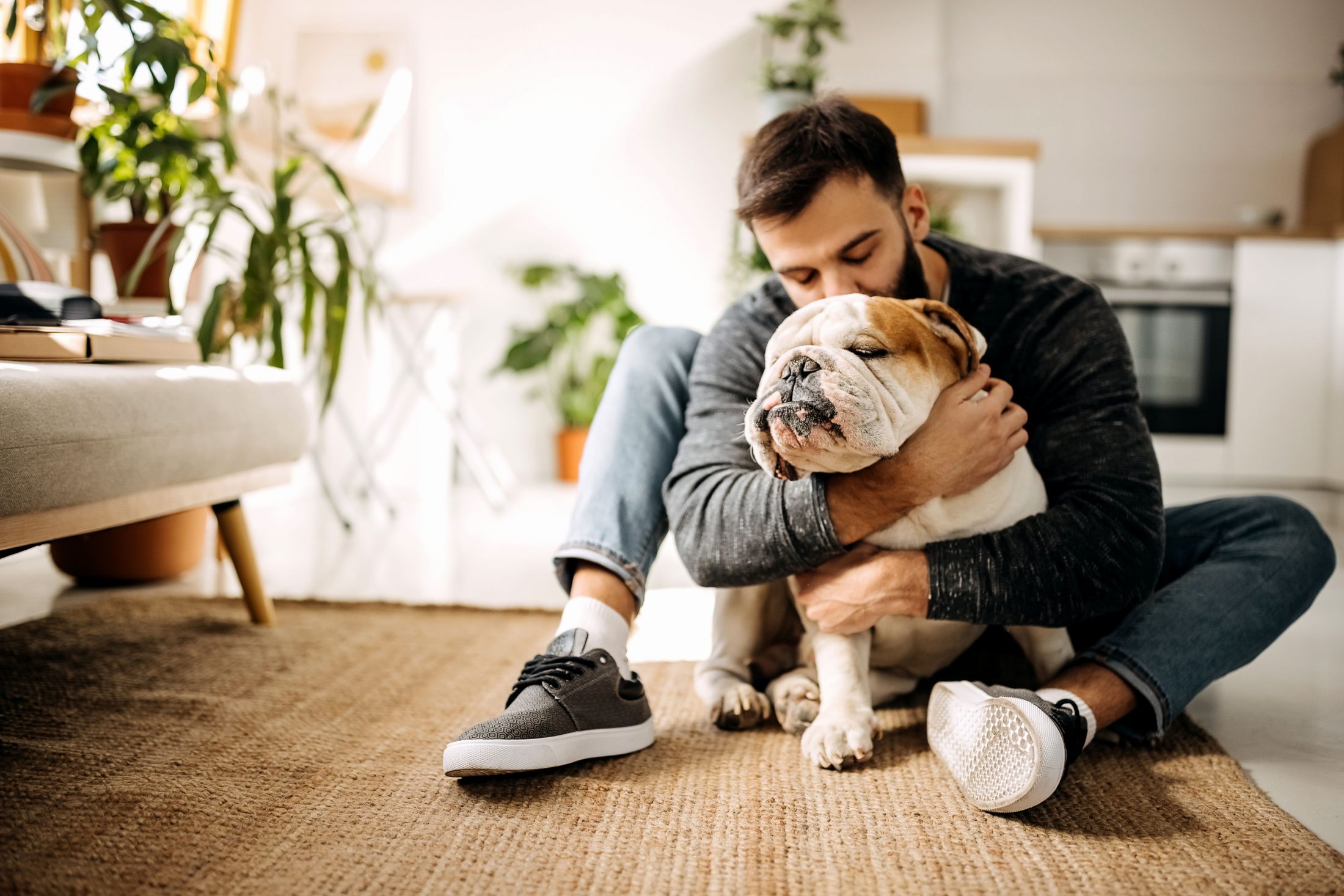 Owner hugging bulldog. 